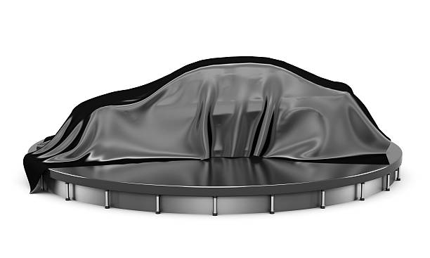 Car on the podium covered with a black satin cloth.