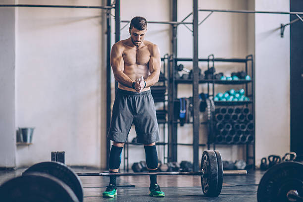 Be proud, but never satisfied. Young man exercising deadlift in gym. Professional athlete. Wearing sports clothing. crossfit chalk weightlifting weight training stock pictures, royalty-free photos & images