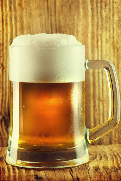 istock Beer by the glass on a wooden background. 599783442