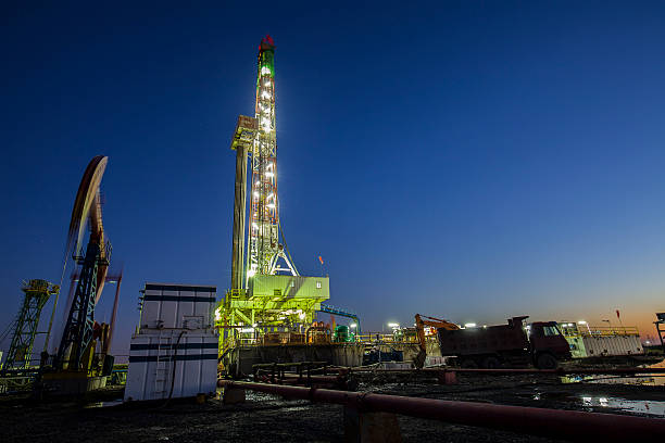 istock oilfield derrick at night 599783906