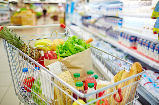 Different kinds of fresh food products in cart