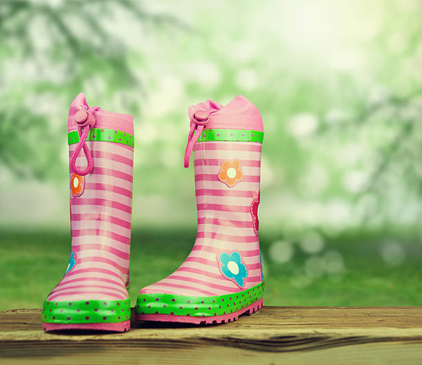 istock colorful rubber boots on nature background. 599784102
