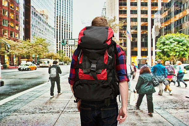 Backpacker walking at street in the cityhttp://www.twodozendesign.info/i/1.png