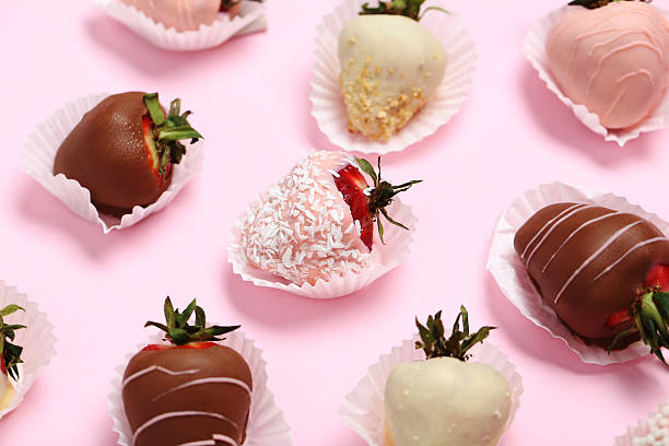 istock Strawberries covered in chocolate on a pink background 599784232