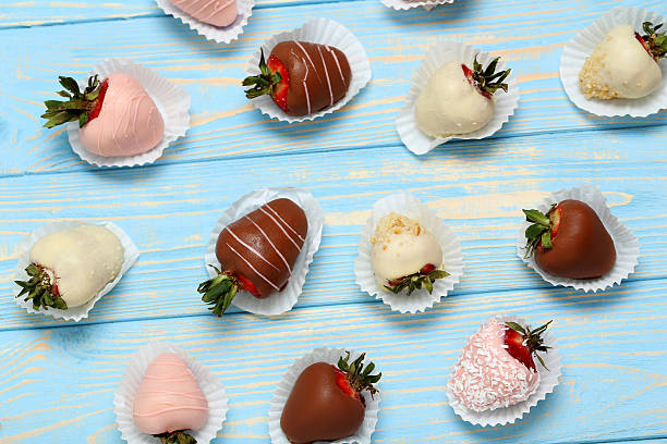 istock Strawberries covered in chocolate on a blue wooden table 599784444