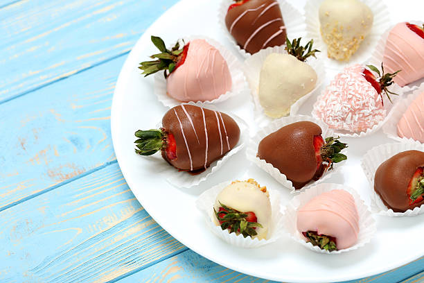 istock Strawberries covered in chocolate on a blue wooden table 599784492