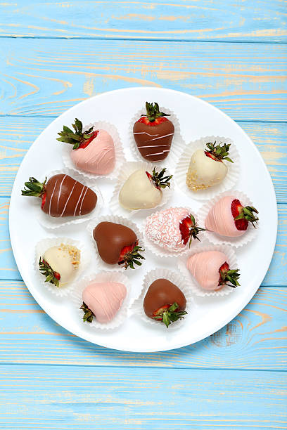istock Strawberries covered in chocolate on a blue wooden table 599784558