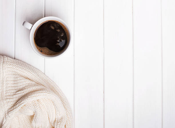 istock Cup of coffee and knitted sweater 599786964