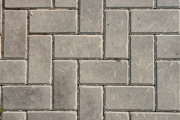 istock Grey brick stone street road. pavement texture 599790470