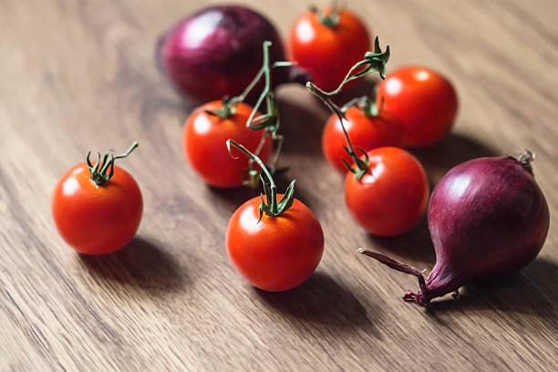 istock Fresh Cherry Tomatoes And Purple Onions 599791128