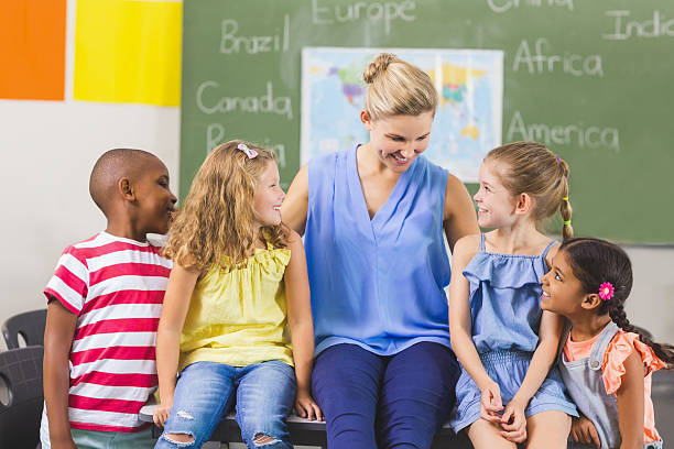 istock Teacher and kids having fun in classroom 599792134
