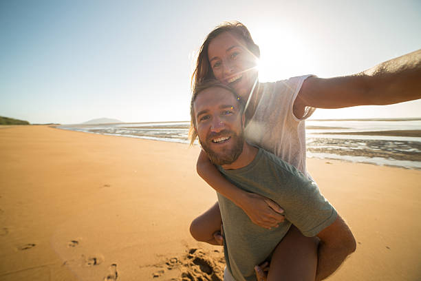 istock Selfie : Couple capturing fun moments on the beach 599793202