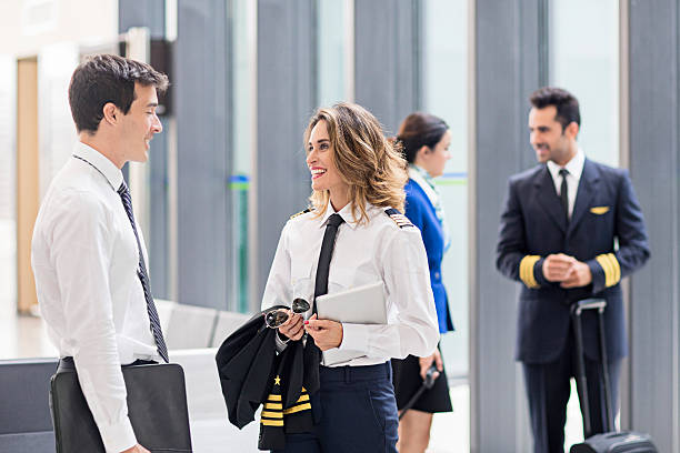 istock Pilot and flight attendants talking in the airport 599794152