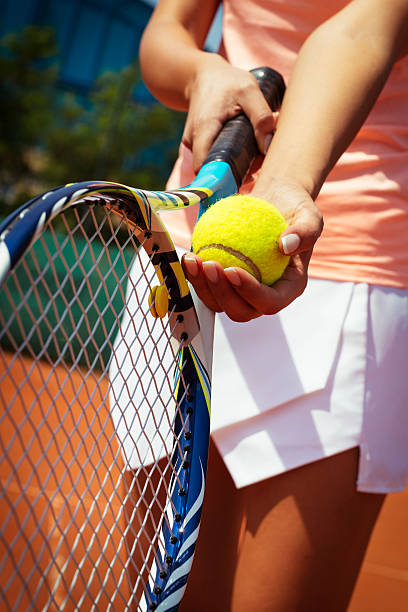 istock Tennis player holding racket and ball in hands 599866588