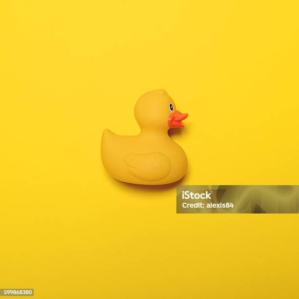 Yellow Rubber Duck On Yellow Background Minimal Design Stock Photo - Download Image Now