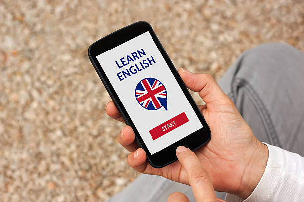 istock Hands holding smartphone with online learn English concept on screen 599870882
