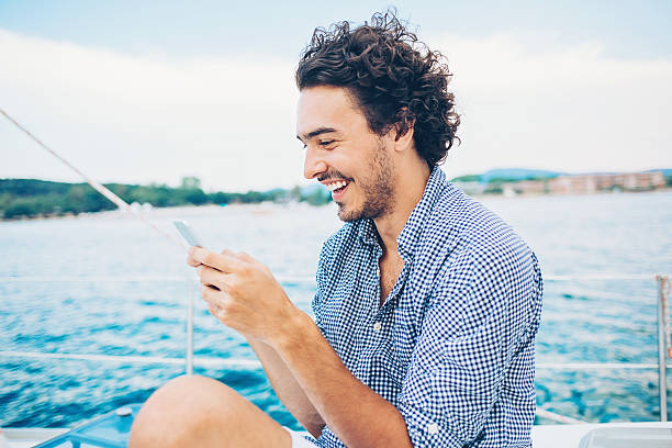 istock Man traveling in the sea and texting 599872430