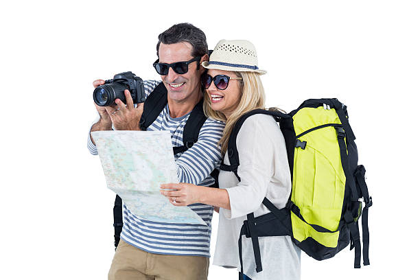 istock Couple looking in camera while carrying luggage 599873114