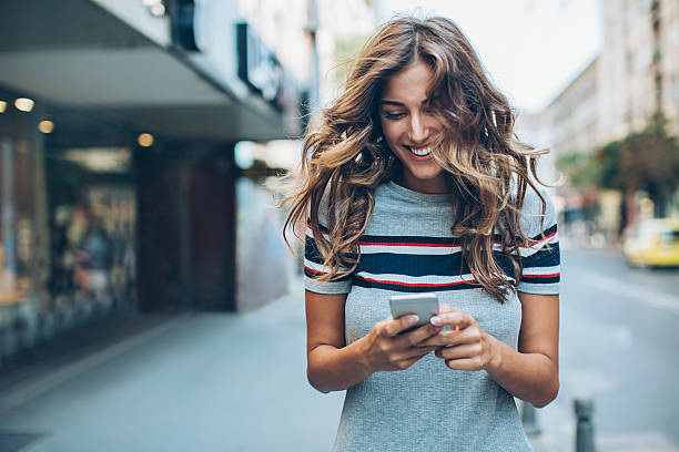istock Beautiful city girl texting 599873948