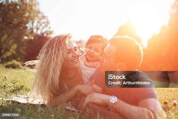 Happy Young Family Spending Time Together Outside In Green Nature Stock Photo - Download Image Now