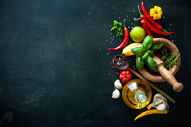 Herbs and spices on slate background Herbs and spices with olive oil on slate background cooking with garlic stock pictures, royalty-free photos & images