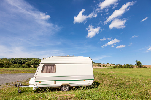 Small caravan on a green camping site in the summertime 