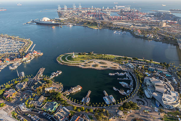 Long Beach Rainbow Harbor Aerial View Long Beach, California, USA - August 16, 2016:  Afternoon aerial view of Rainbow Harbor, tour ships, aquarium and Queen Mary attractions.   long beach california photos stock pictures, royalty-free photos & images