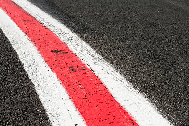 istock Turning red and white lines on dark grey asphalt 599881658