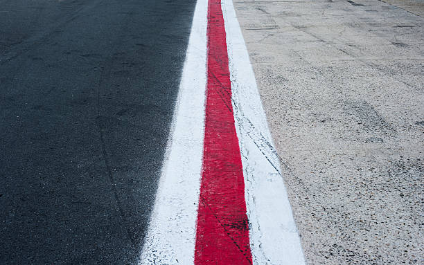 istock Vertical red and white lines on dark grey asphalt 599881722