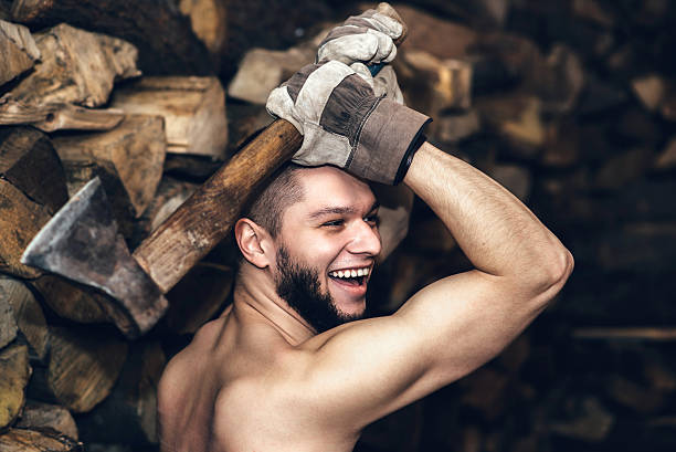 Man with an ax near firewood stock stock photo