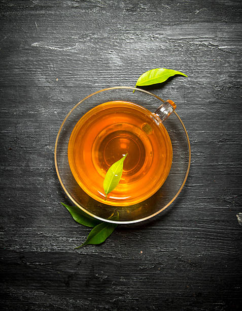 istock Cup of tea with green leaves. 599884814
