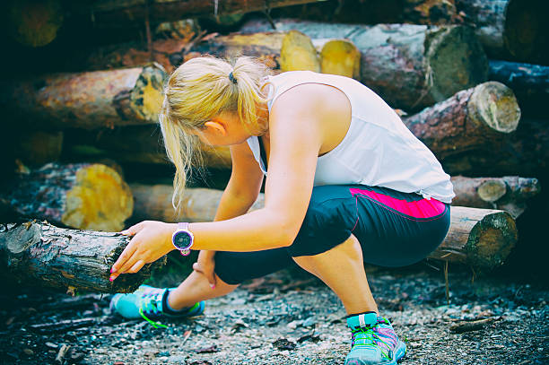 istock Female runner stretching legs on mountain trail 599885504