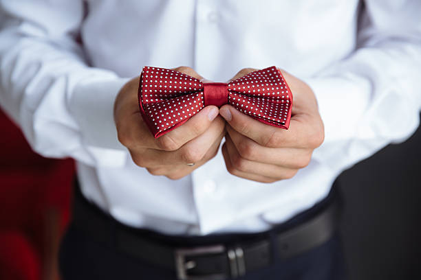 istock Man holding bow tie. Elegant gentleman clother. 599886742