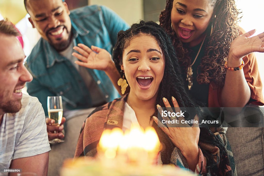 OMG, guys you shouldn't have... Shot of a young woman celebrating her birthday with her friends Candid Stock Photo