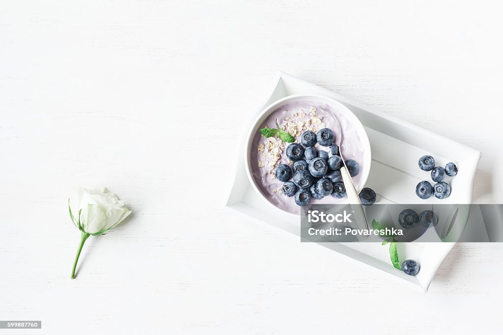 Healthy breakfast with yogurt, muesli and blueberry. Flat lay Healthy breakfast with yogurt, muesli and blueberry. Top view, flat lay Blueberry Stock Photo