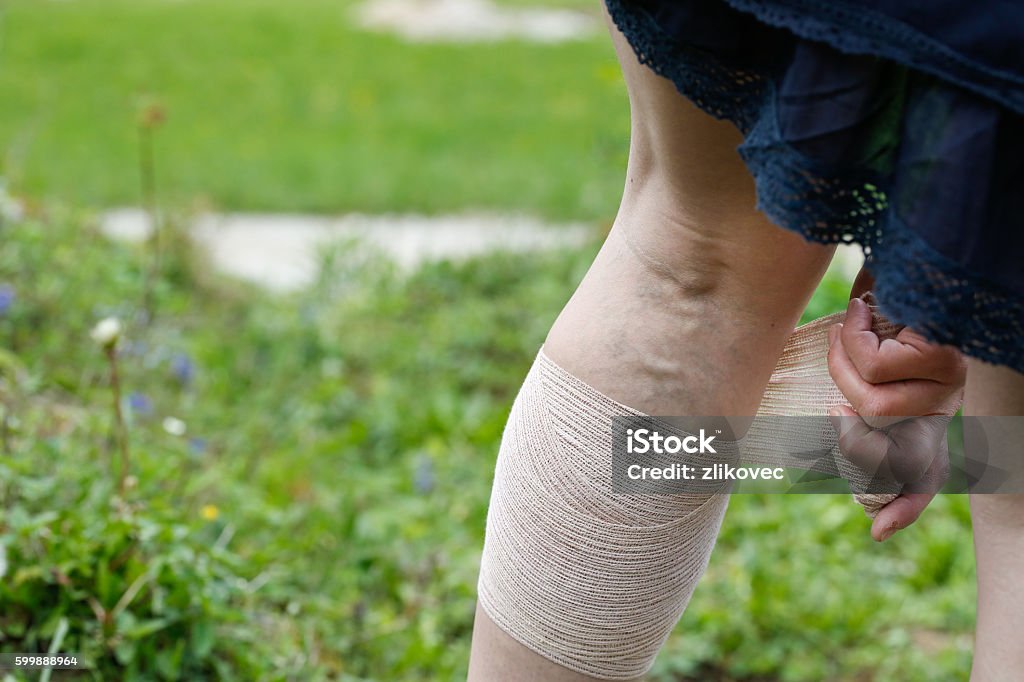 Woman with varicose veins applying compression bandage Woman with painful varicose and spider veins on her legs, applying compression bandage, self-helping herself. Vascular disease, varicose veins problems, painful unaesthetic medical condition concept. Pregnant Stock Photo