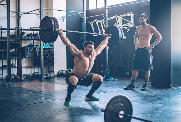 Go hard or go home. Young men exercising deadlift in gym. Professional athletes. Wearing sports clothing. crossfit chalk weightlifting weight training stock pictures, royalty-free photos & images