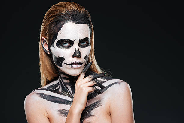 istock Young woman with gothic skeleton makeup 599892574