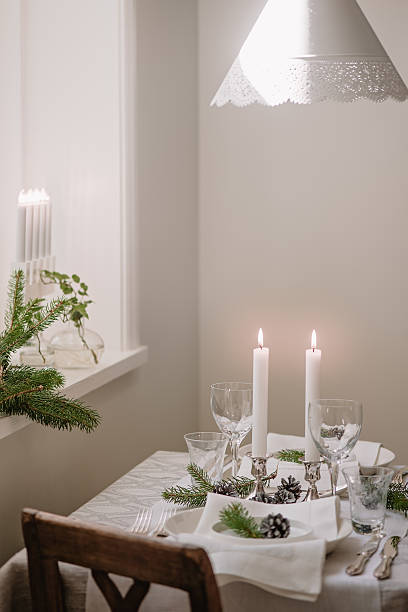 istock White christmas table setting with cone and fir 599893528
