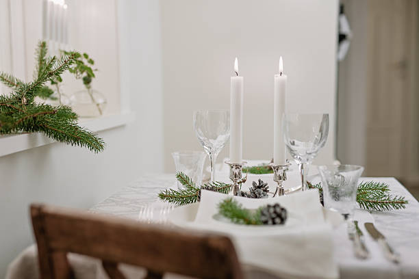 istock White christmas table setting with cone and fir 599893604