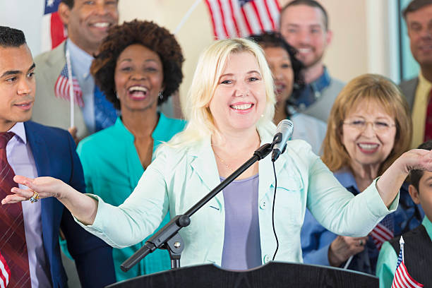 istock Woman speaking during political rally to support candidate 599893900