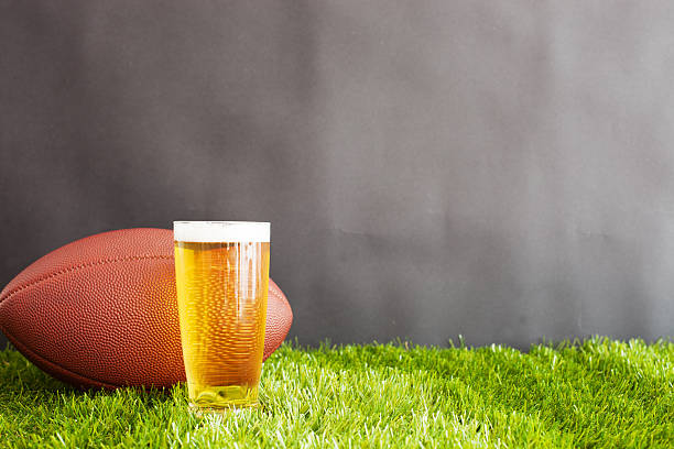 istock Football over grass and beer 599895364