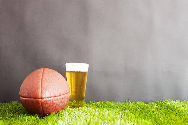 istock Football over grass and beer 599895556