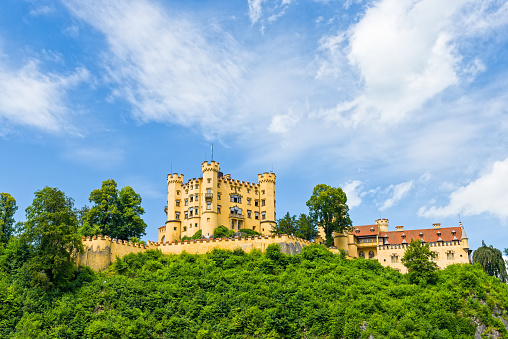 Fussen, Germany - July 9, 2016: The Hohenschwangau Castle is a 19th-century palace in southern Germany. It is located in the German village of Hohenschwangau near the town of Fussen,  in southwestern Bavaria, Germany. It was rebuilt on old castle according to original plans by King Maximilian II of Bavaria, at the nineteenth century. Hohenschwangau Castle was one of the summer residences for the bavarian royal family.
