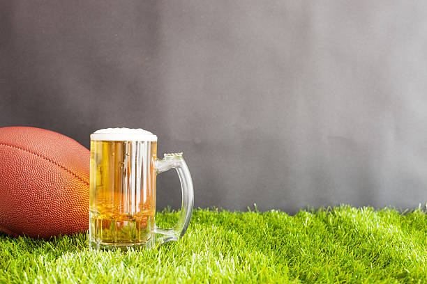 istock Football over grass and beer 599896024