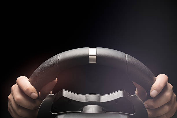 Cropped image of an adult playing car racing video game at home