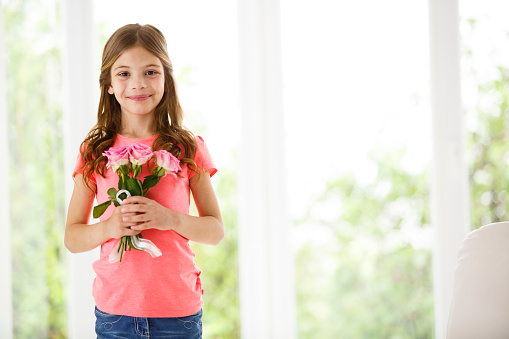 Young girl with bouquet of pink roses