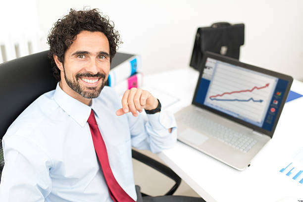 istock Happy businessman in front of his laptop computer 599897394