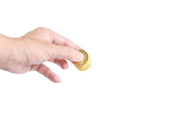 チョコレートゴールドのコインを手白を背景にした - imitation currency paper currency gold ストックフォトと画像