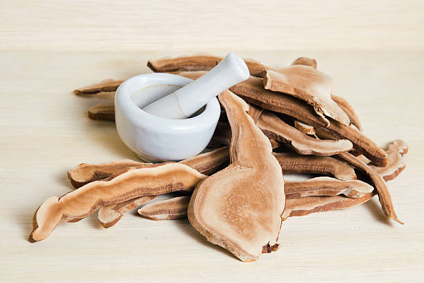 Lingzhi mushroom, Chinese traditional medicine, Ganoderma Lucidu Dried lingzhi mushroom (Also called as Reishi mushroom in Japan, Lingcheu in Thailand, Lingzhi mushroom in China, Ganoderma Lucidum Karst or lacquered mushroom) on wood background ganoderma lucidum stock pictures, royalty-free photos & images